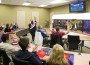 Oakville High School led by St. Louis Rams tackle Adam Goldberg (front, third from the right) and students from Lincoln College Preparatory Academy in Kansas City played by teleconference a virtual, NFL-themed video game testing their financial knowledge.