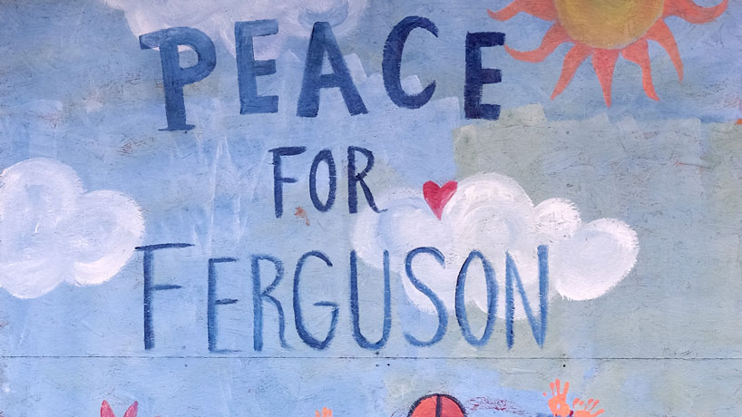 This artwork was one of many artistic expressions painted on the plywood of boarded up businesses on Florissant Road. (Photos by August Jennewein)