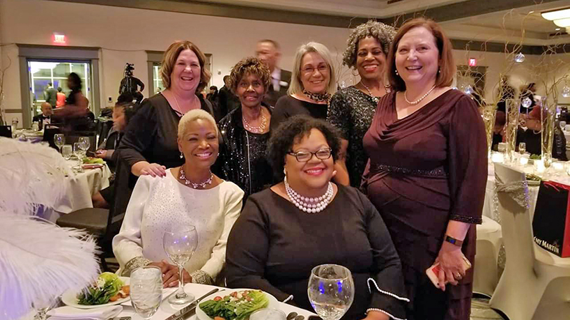 During its annual gala on Saturday, the 100 Black Men awarded Assistant Professor Sheila Grigsby its Pillar Award for Health and Wellness. (bottom row from right) Sheila Grigsby and Theda Oliver. (top row from right) Dean Susan Dean-Baar, Associate Professor Wilma Calvert, Donald L. Ross Endowed Chair for Advancing Nursing Practice Roxanne Vandermause, Instructor Gwendolyn Stubblefield and Assistant Teaching Professor Beth Dudley. 