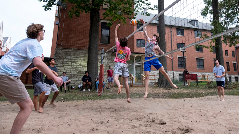 Students play sand volleyball on South Campus