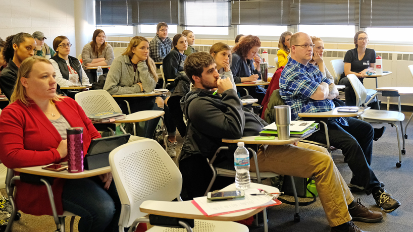 Students sit and listen intently in class