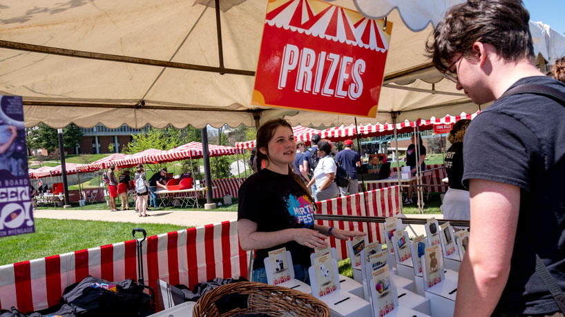 A student looks over the potential prizes at the Mirthweek Carnival