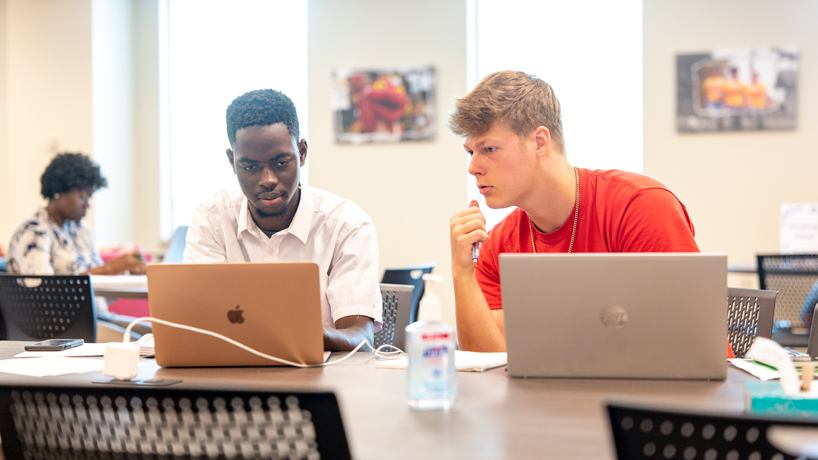 Chris Bartholomew helps Mamadou Thiam with calculus in the MSC