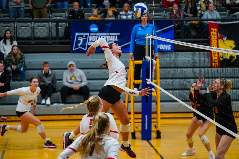 Middle blocker Hannah Copeland leaps and swings a ball against Ferris State