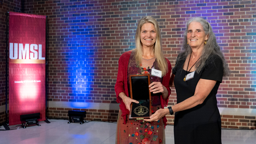 Alumna Jaqueline Goerck accepts the Robert R. Hermann World Ecology Award from her former PhD advisor Bette Loiselle