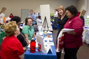 Caitlin Downey (second from right) and Jaime L. Lincoln (right) share a laugh with YMCA representatives (from left) Tiffany Barke, Sherita Love and Jeni Koenigsfeld during the Employee Volunteer Program Fair held Thursday at UMSL.
