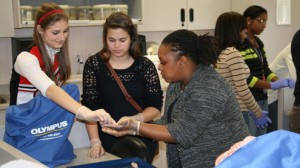 Dr. Angel Novel-Simmons (right), clinical assistant professor of optometry at UMSL, and students from Hazelwood West High School