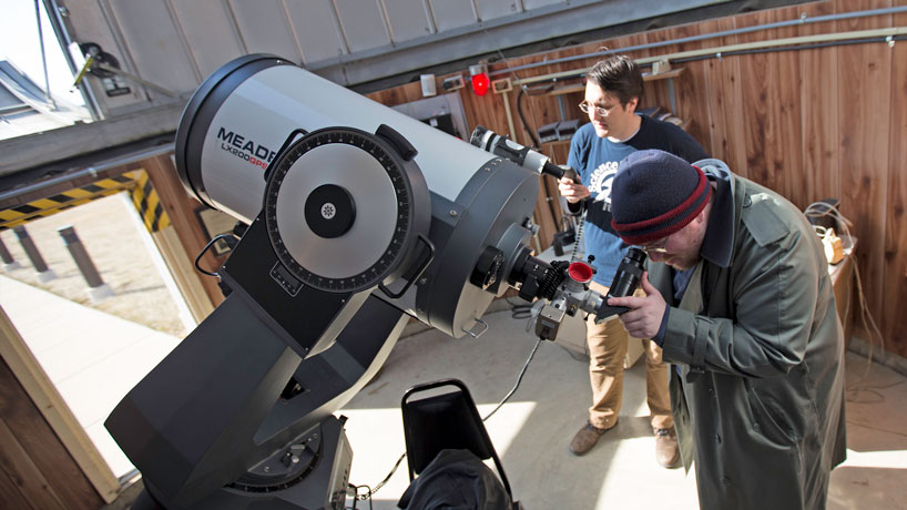 Astrophysics students Matt Dennis (front) and Matt Wentzel run the 2015 Richard D. Schwartz Observatory Open House. The next open house is at 8 p.m. on Saturday, March 28. (Photo by August Jennewein)
