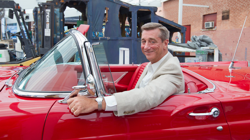 Denny Reagan sits inside a prop car on the back lot of The Muny. The UMSL alumnus has worked at the outdoor musical theater for 47 years. (Photo by August Jennewein)