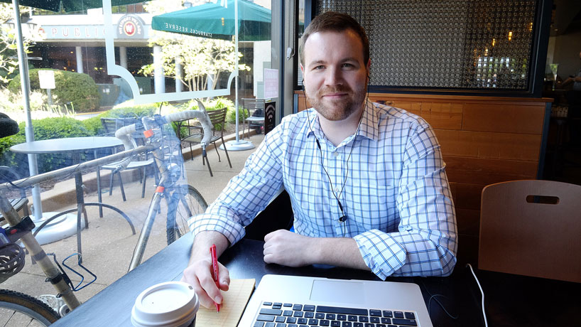 Computer science graduate student Eryn Cantrell works in his local coffee shop on his iOS game app, which helped land him his summer internship at the application and mobile development company Asynchrony in St. Louis. (Photo by August Jennewein)
