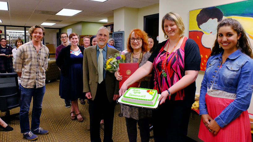 Surrounded by students and colleagues, Professor of English and Director of Gender Studies Sally Barr Ebest (center with envelope) was surprised Thursday afternoon by UMSL Chancellor Tom George on behalf of the UM System with a 2016 President’s Award for Service. (Photo by August Jennewein)
