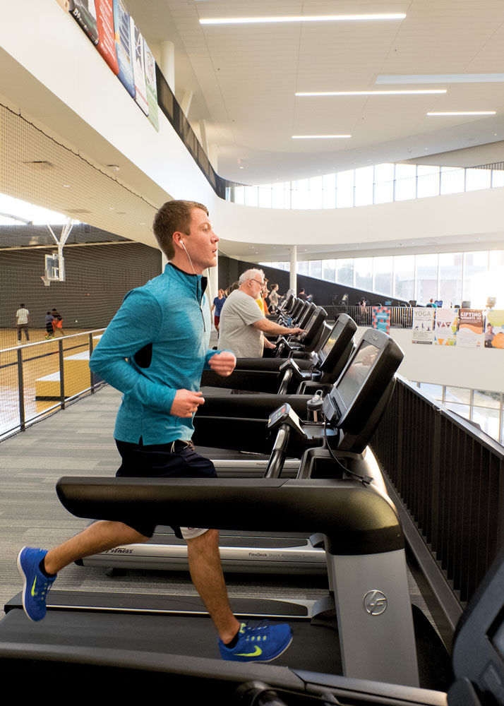 At the Recreation and Wellness Center where he worked as a student manager, Cameron gets a run in on a second-floor treadmill overlooking the weightlifting area on the ground floor below.