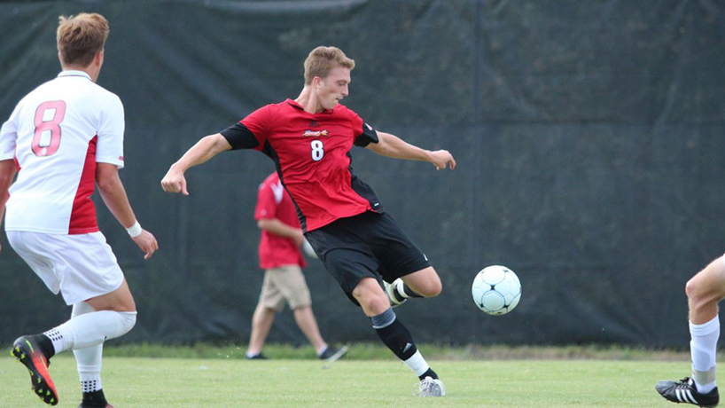 UMSL soccer player Clay Stocker kicks the ball.
