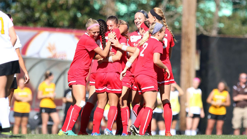 Members of the UMSL women's soccer team huddle together while celebrating a 3-1 victory against Wisconsin-Parkside.