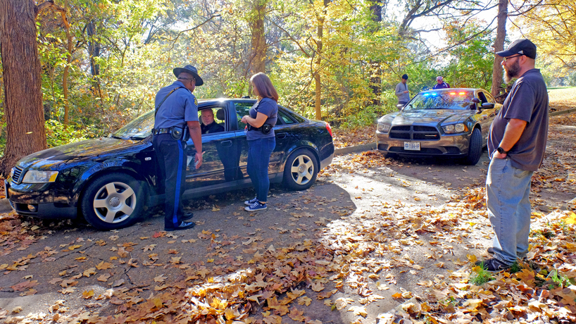 Missouri State Highway Patrol troopers Ben Jones, left, talks with sophomore Edie Hammett during a mock traffic stop while others, including associate professor Terrance Taylor observe, on Friday afternoon.