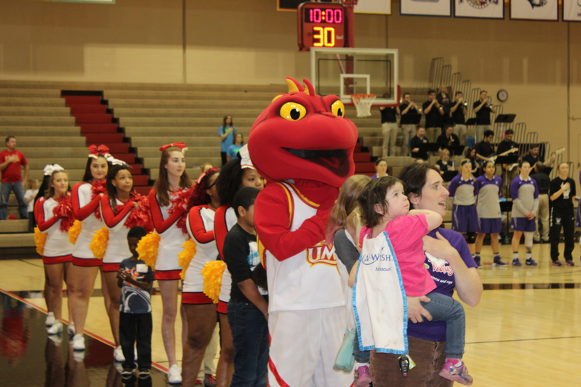 Wish kids and UMSL cheerleaders standing for the national anthem