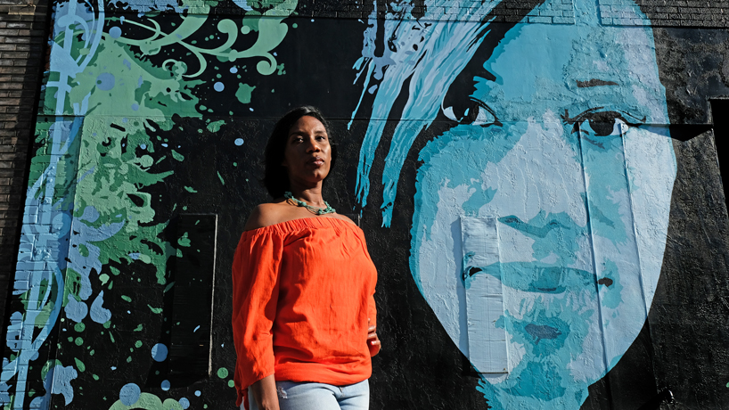 Jacqueline Thompson in front of mural in the Grove