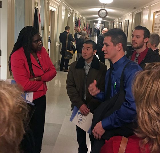 Robert Bohnert (right in blue) talks with Representative LaKeySha Bosley (left) about the shortage of primary care providers in Missouri and how nurse practitioners could help. 