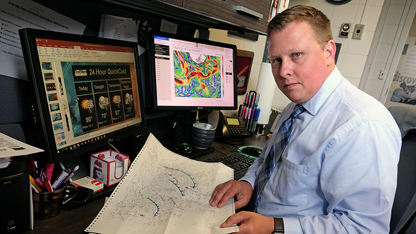 Nick Palisch's first passion was meteorology and he wakes at 4:30 a.m. to put together a forecast for community newspapers and his Facebook page, Firstwarn Weather. (Photo by August Jennewein)