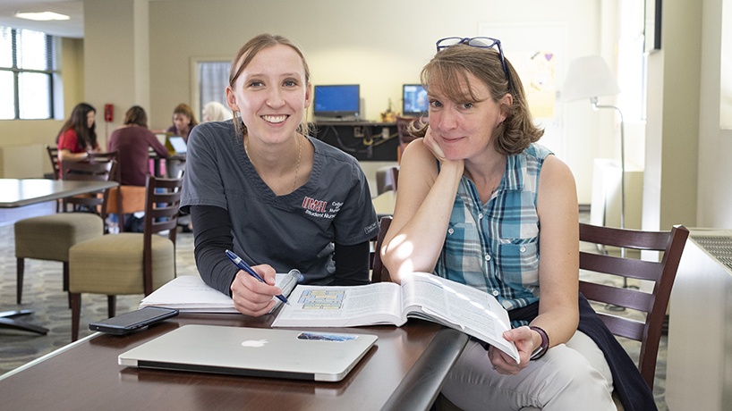 Mother and daughter Kristin and Clare Vogt were caught in a rare moment of studying together. Though they are both College of Nursing BSN students, one is in the traditional and the other is in the accelerated program, which means they don't take the same classes. (Photo by August Jennewein)