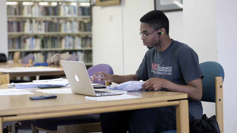 student studying in library