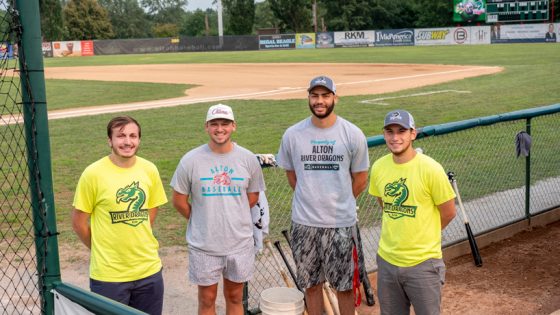 Alton River Dragons interns posing on baseball field