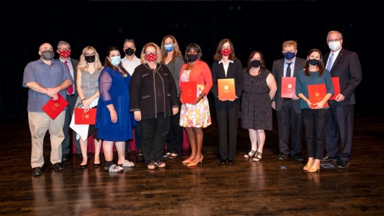 Chancellor's Award winners on stage with chancellor