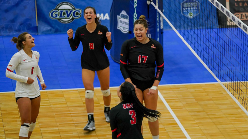 UMSL volleyball players celebrate on the court