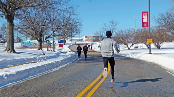 Members of the UMSL cross country team run amid the snow on South Campus