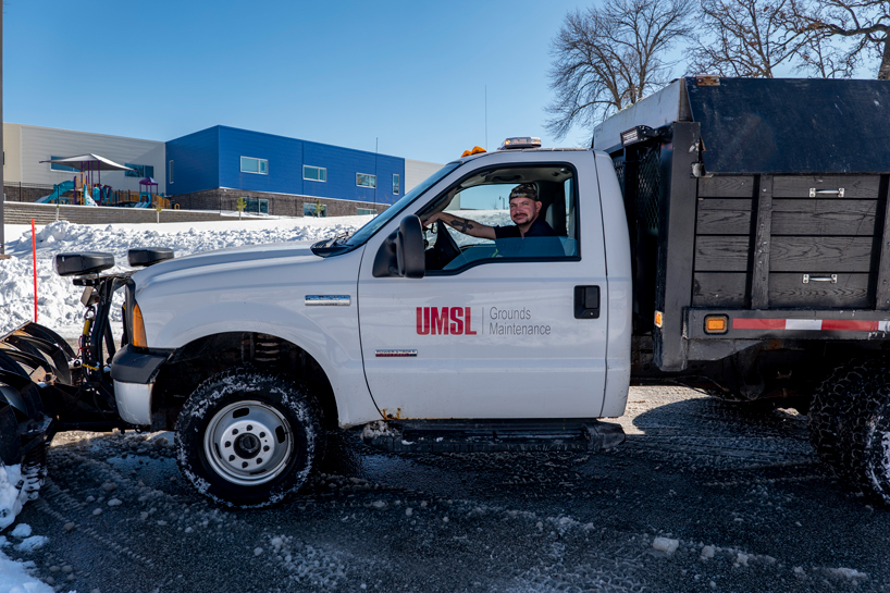 Kristoffer Tomlinson plows the parking lot outside Woods Hall