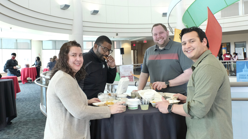 Emily Davidson, Barry Greene Jr., Andy Bruni and Daniel Provencio enjoy food in the rotunda of the Millennium Student Center during the Soul Food Celebration