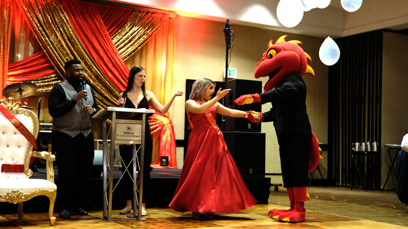 Homecoming royalty candidate Alivia Hall dances with Louie during the homecoming dinner and dance
