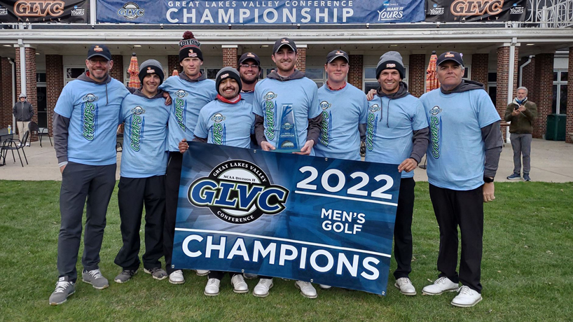 UMSL men's golfers post with a banner recognizing their Great Lakes Valley Conference championship