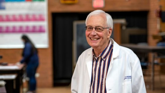 Charles Granger smiles in lab coat