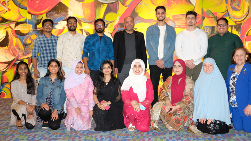 Muslim and Indian students and two faculty members gather in the Pilot House
