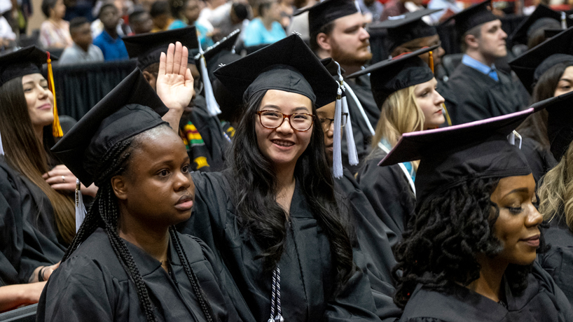 A student waves during a commencement ceremony