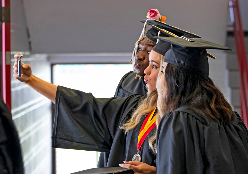 Students gather for a selfie before Spring 2022 Commencement ceremony