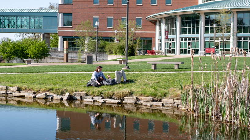 Nicole Shelley and Atharv Kulkarni relax by the Egret Pond