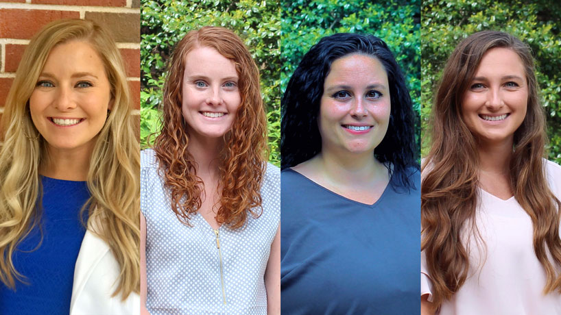 Four female optometry students smile.