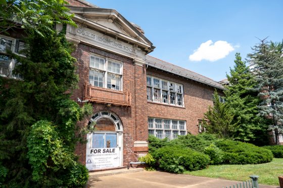 Former Charles Turner Open Air School building in disrepair with broken windows an a for sale sign