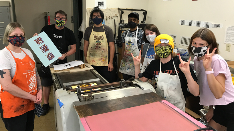 Scott Gericke works with graphic design students in the printmaking studio