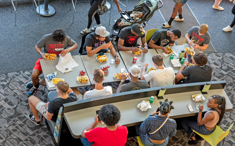 Students gather around a table in the MSC to eat during the Welcome Back Bash