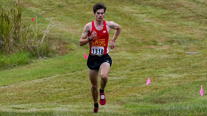 UMSL cross country runner Toby Middleton runs up a hill alone