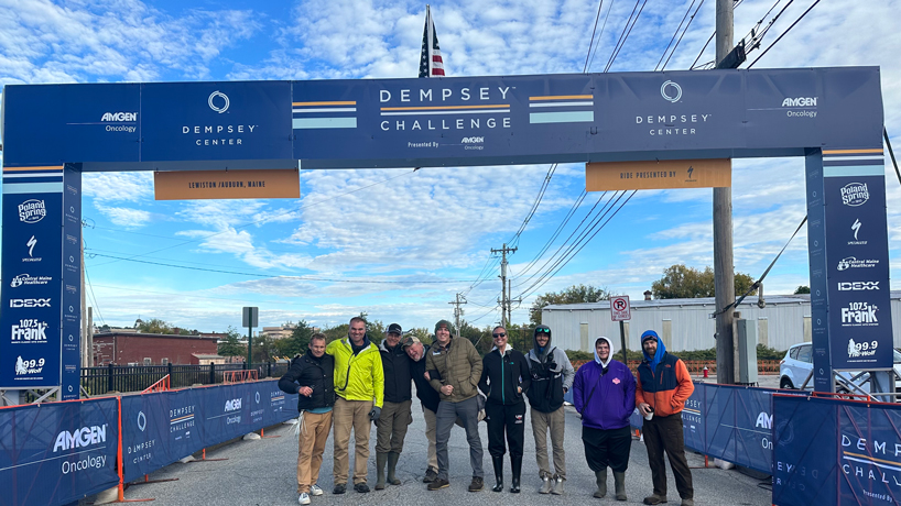 Alex Elmore and fellow volunteers stand at the Dempsey Challenge Finish Line