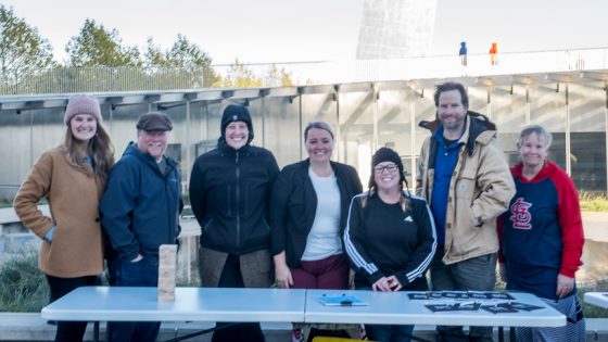 Gateway Writing Project members welcome passersby at the Arch plaza.