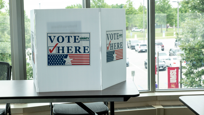 A partition setting off a voting booth rests on a table in the Millennium Student Center