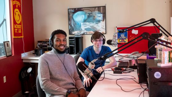 Jalen Walker-Wright and Aden Adams sit together in the UMSL Radio studio behind mics with headphones on