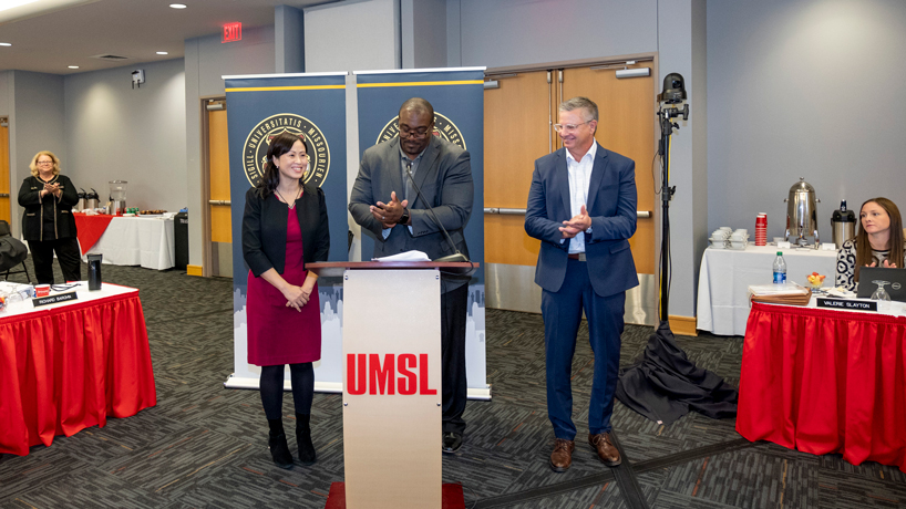 Curator Darryl Chatman applauds new Curators' Distinguished Professors Gaiyan Zhang and Robert Paul