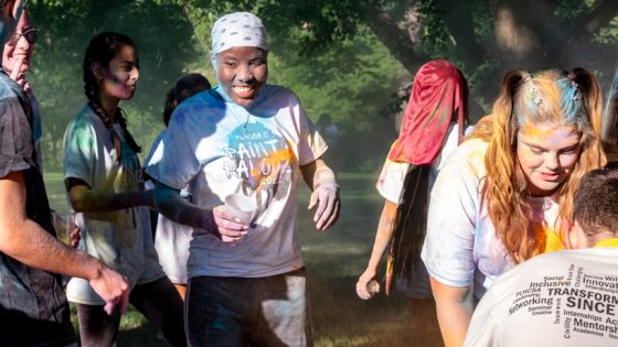 Shakinah Clarke smiles while covered in powder puff paint