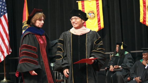PhD graduate Zhonghua Cao stands with advisor Michelle Meckfessel as he receives his degree